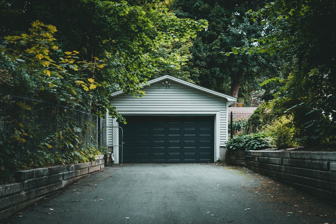 gray wooden house near green trees during daytime