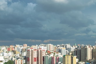 city skyline under gray clouds during daytime