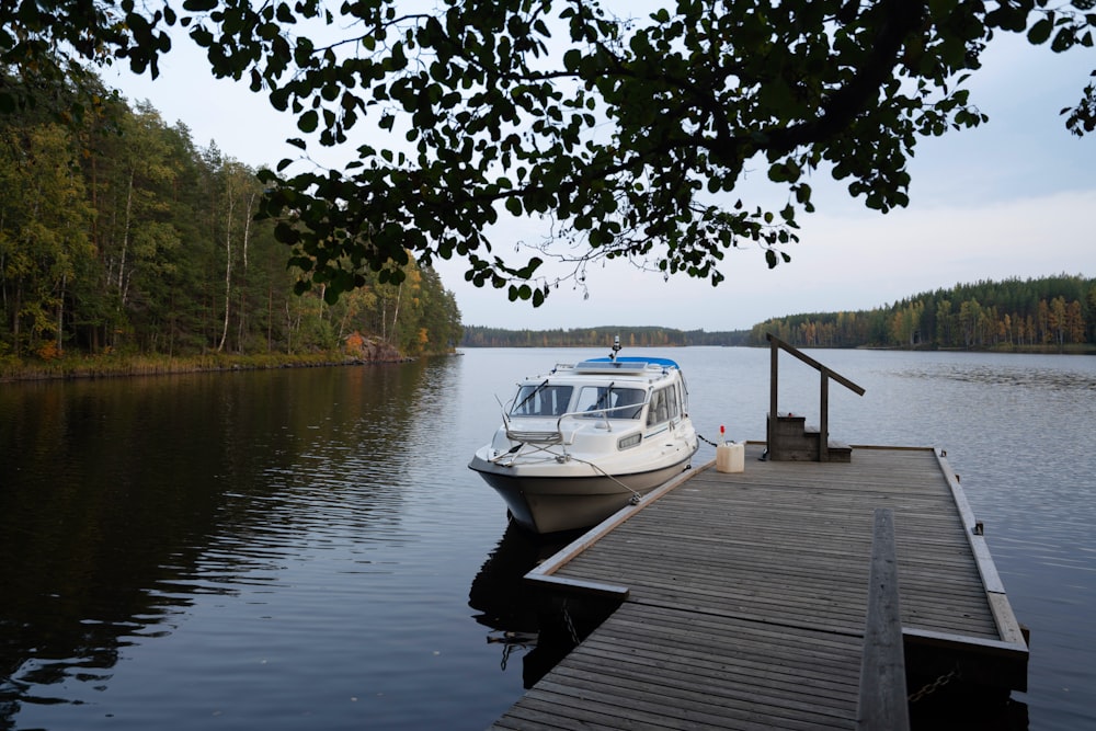 white boat on dock during daytime