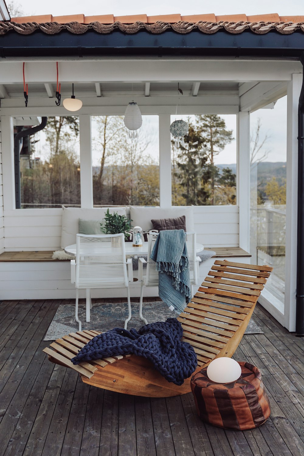 white wooden armchair near glass window