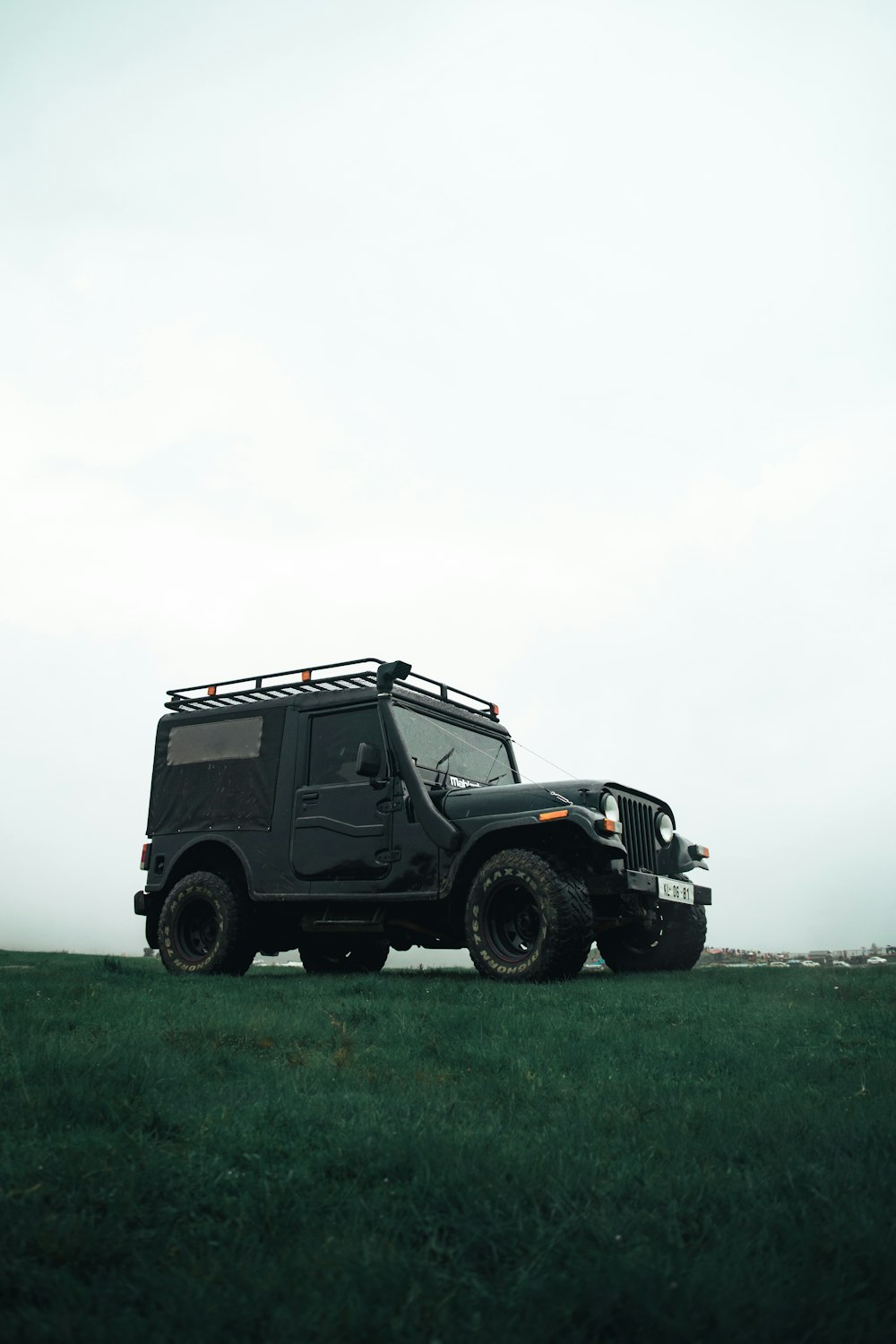 black jeep wrangler on green grass field during daytime