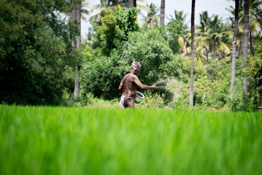 woman in black and white dress running on green grass field during daytime