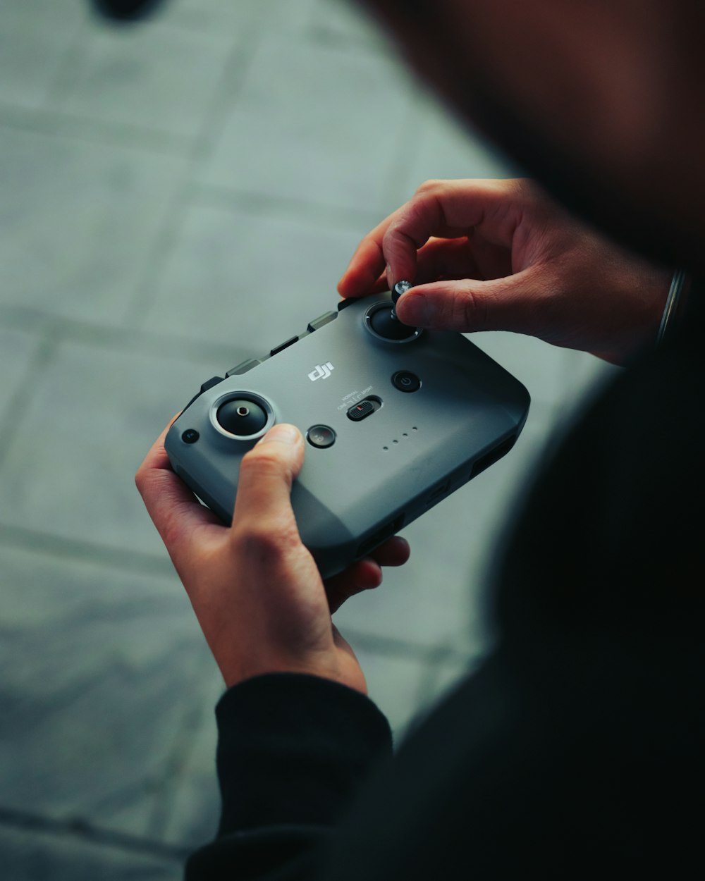 person holding gray game controller