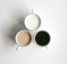 3 white ceramic mugs with brown liquid