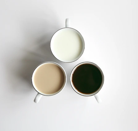 Three puzzle mugs arranged side by side revealing a partial abstract art image.