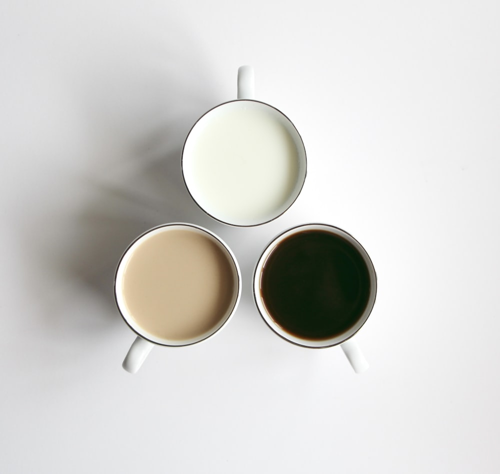 3 white ceramic mugs with brown liquid
