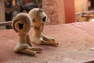 Kids focused on making clay sculptures with joyful expressions.