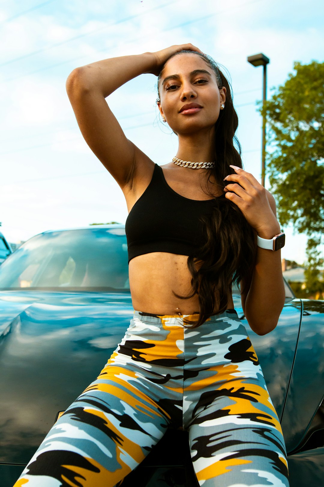 woman in black sports bra and blue white and orange skirt