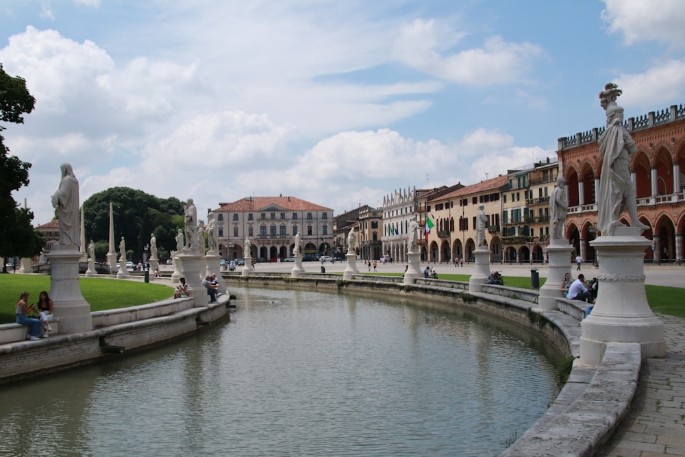 river between concrete buildings during daytime