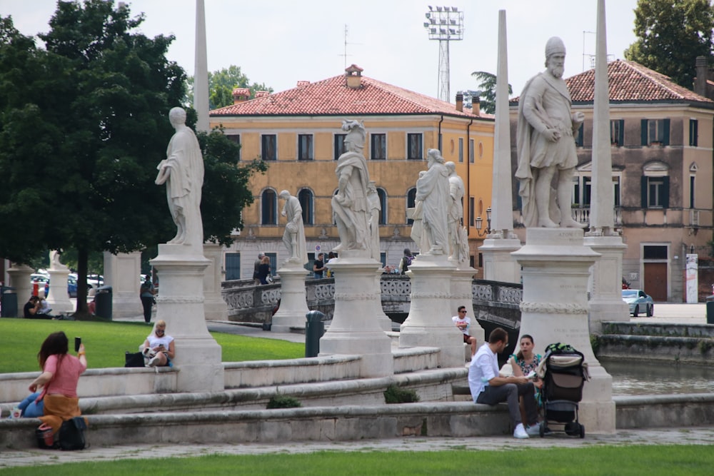 people standing near white statue during daytime