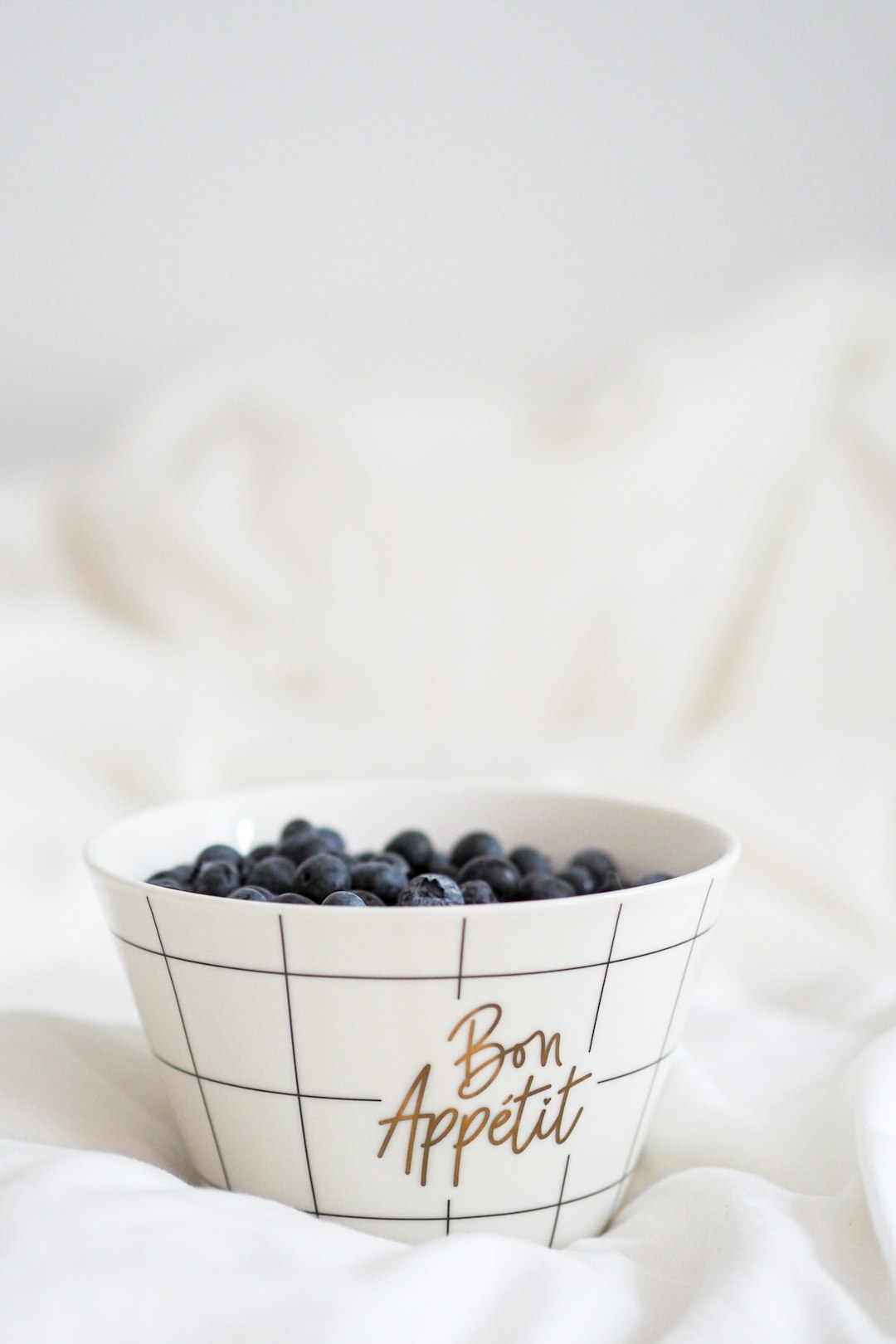 black berries in white ceramic bowl