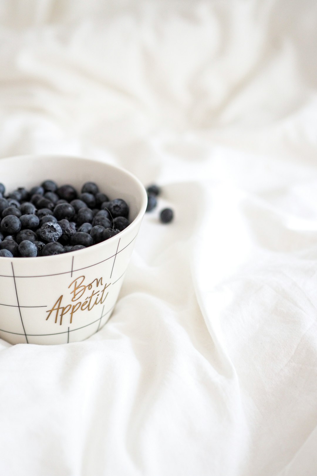 black berries in white ceramic bowl