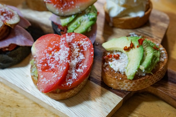 Red tomato on brown wooden chopping board