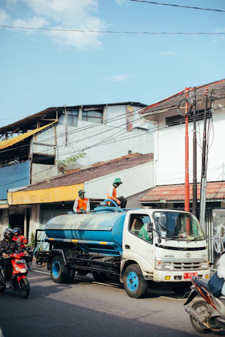 white van parked beside red motorcycle during daytime