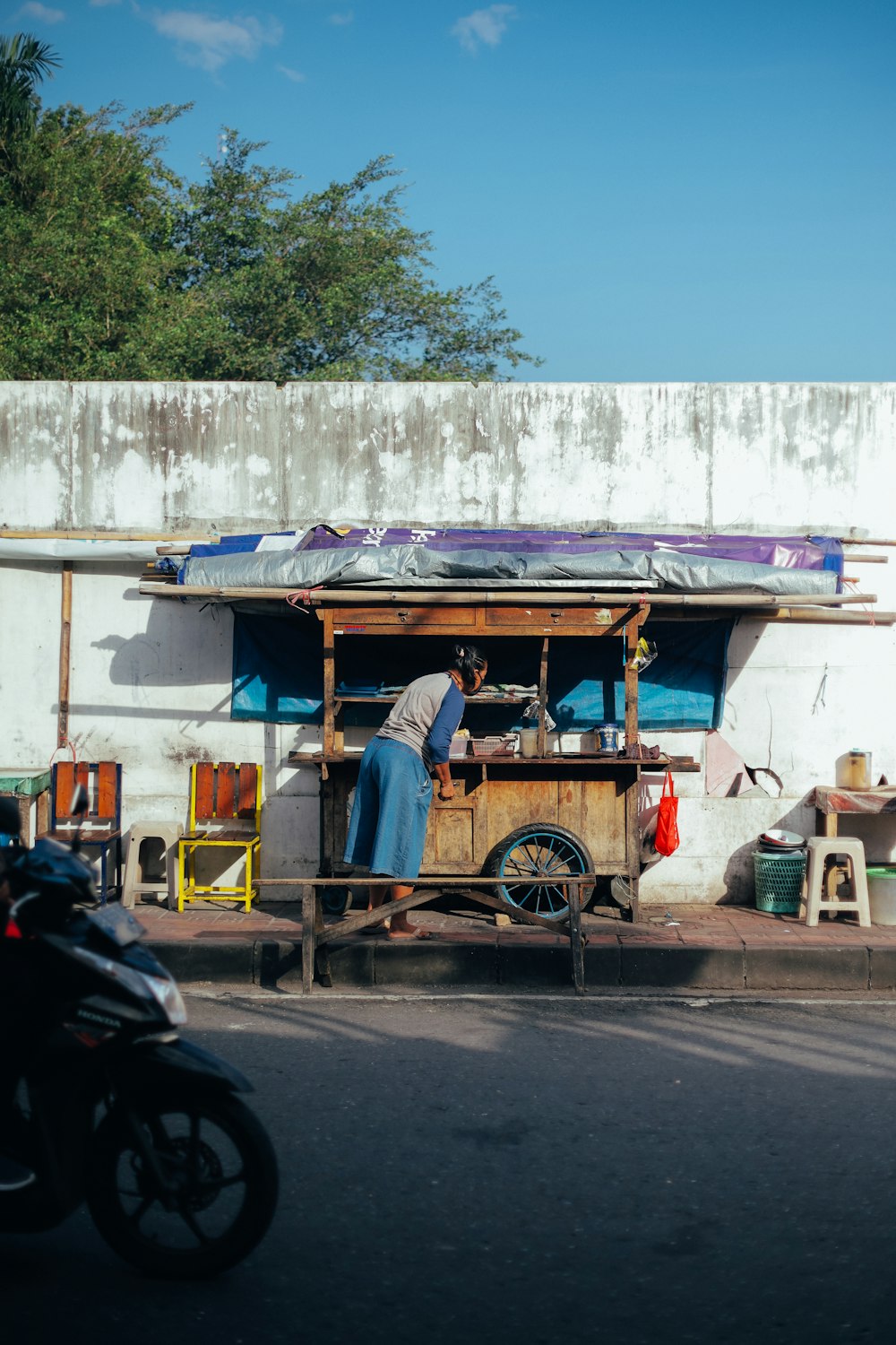 Un homme debout devant un chariot de nourriture
