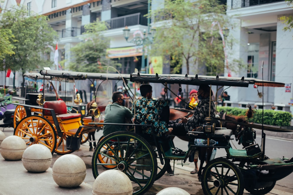 a group of people riding in a horse drawn carriage