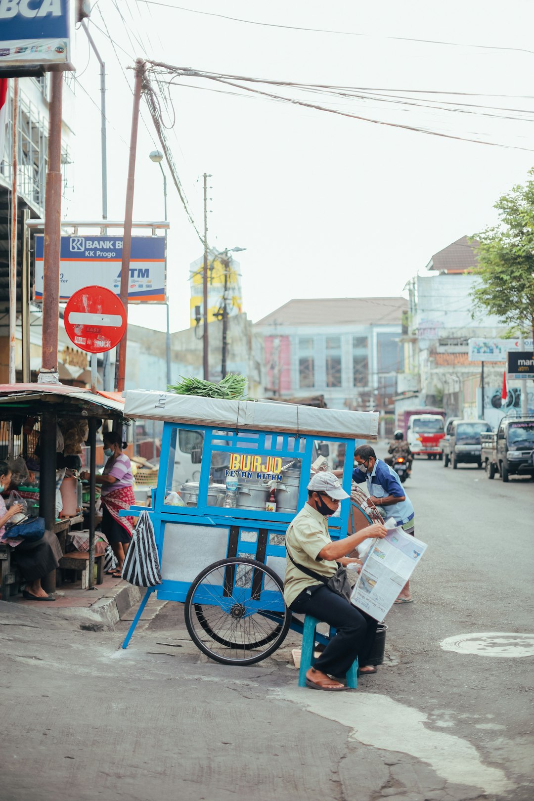 people riding on blue and white trike during daytime