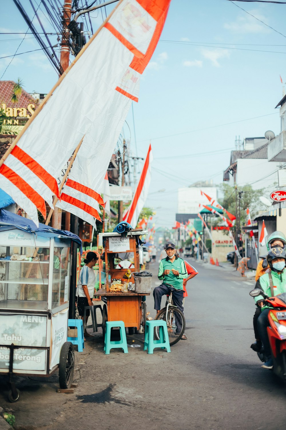 people riding on a food cart during daytime