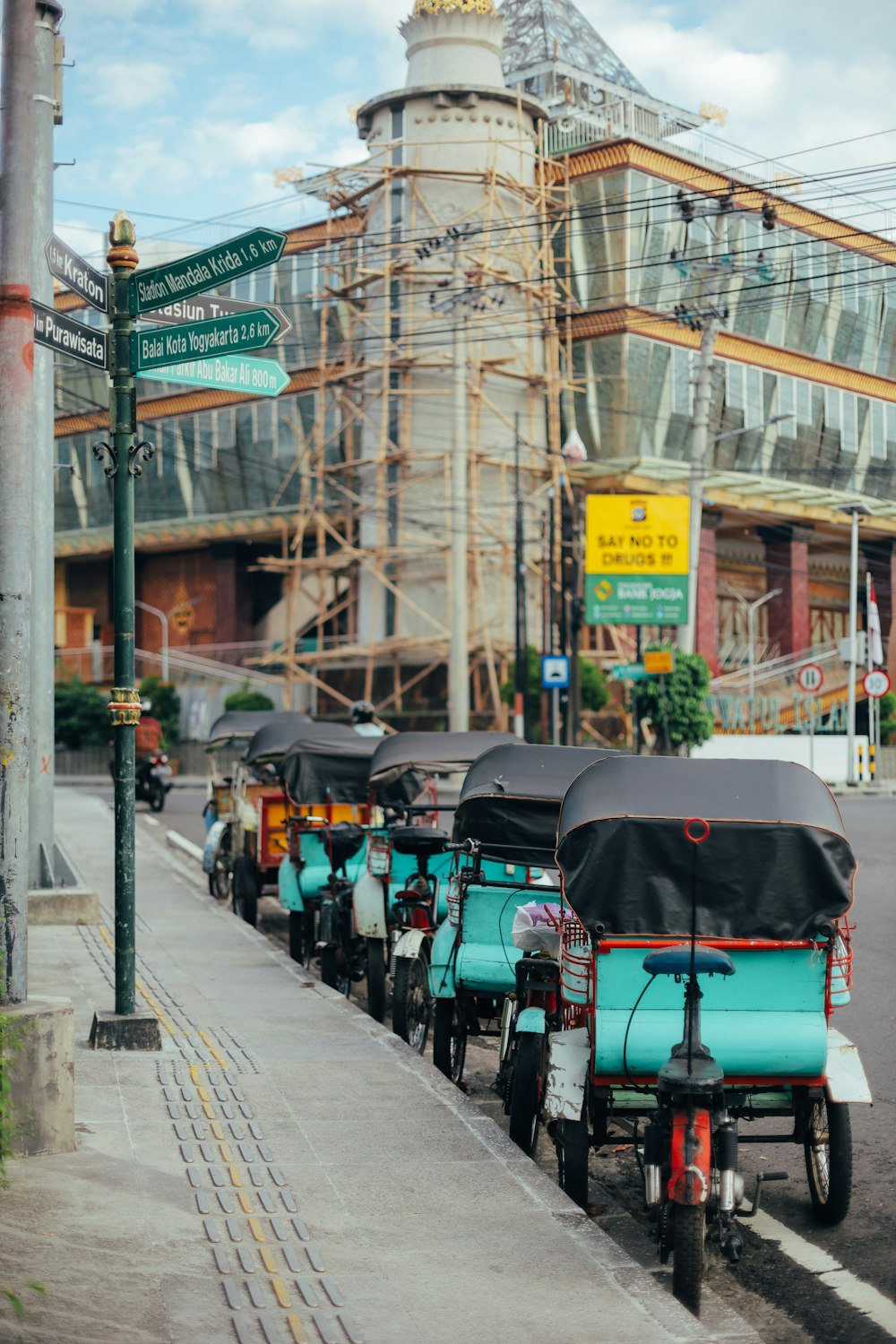 people riding on red and black vehicle on road during daytime