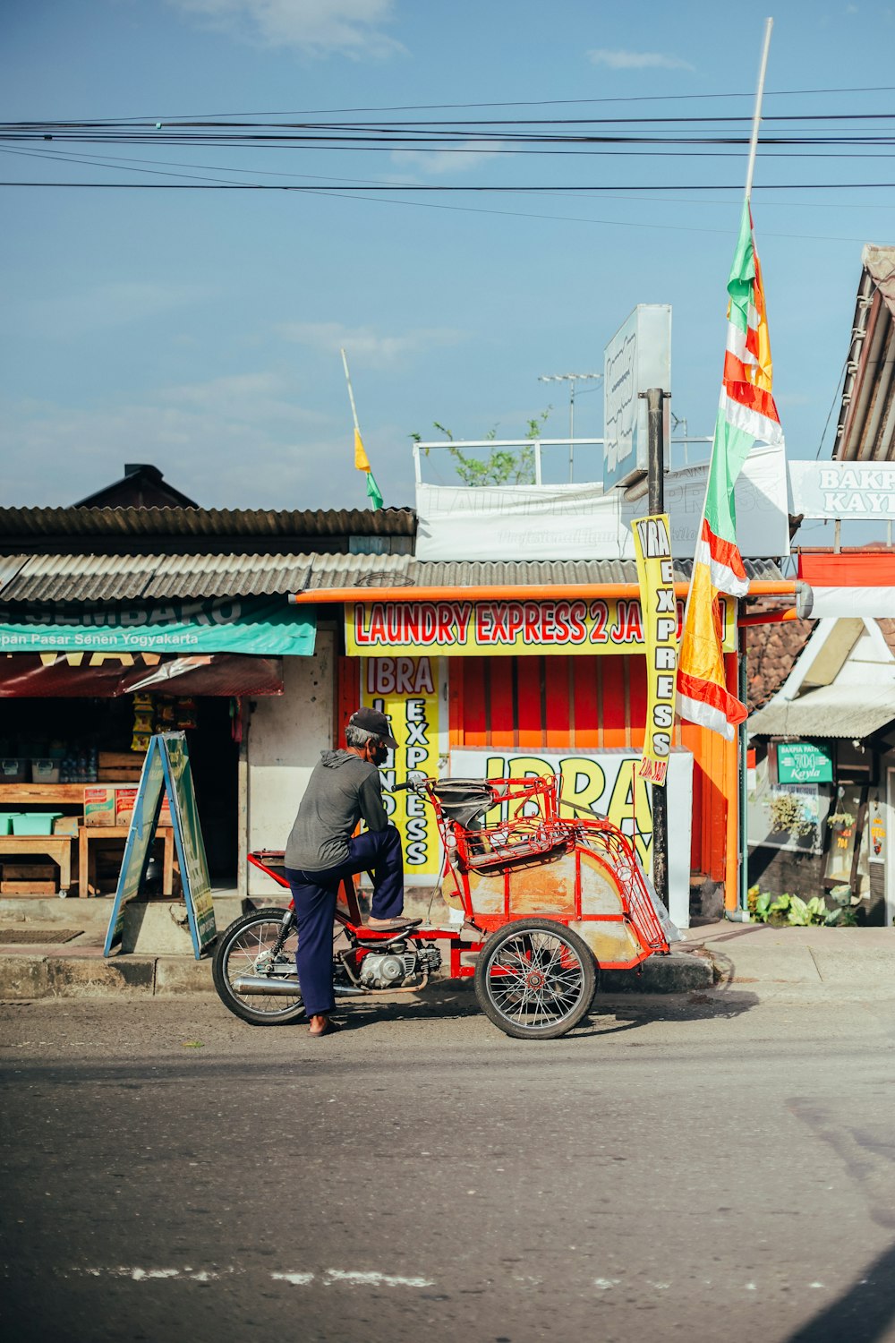 man in black jacket riding on red and yellow motorcycle during daytime