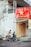 man in white shirt riding motorcycle near building during daytime
