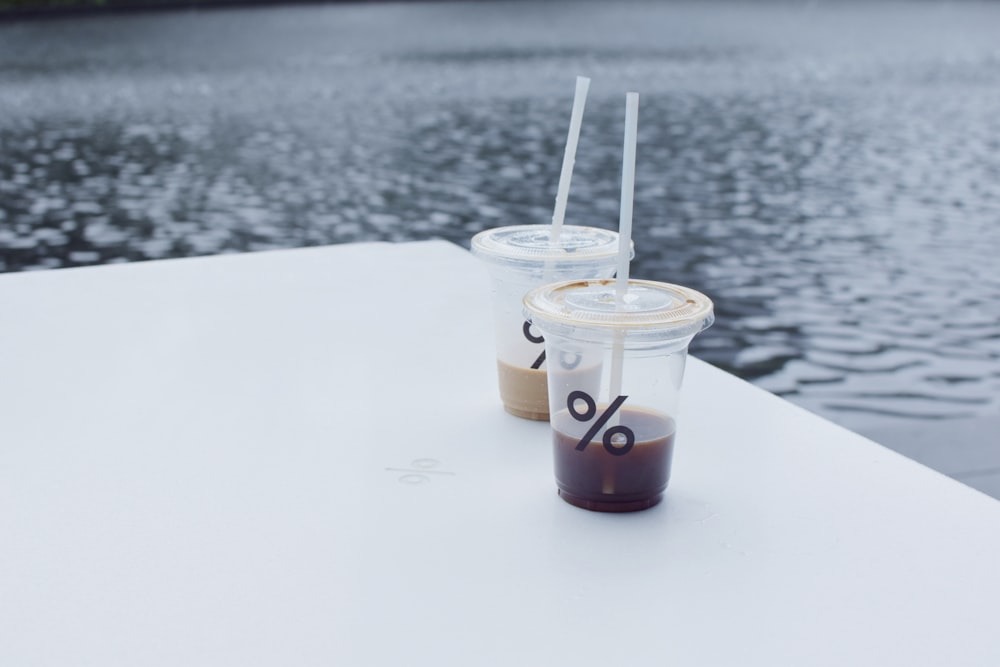 clear plastic cup with white straw