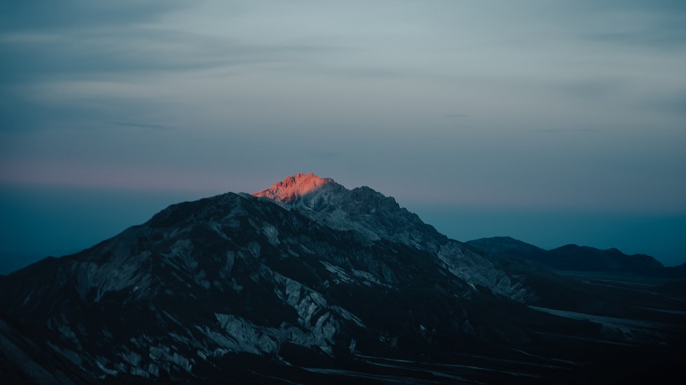 black and white mountains under gray sky