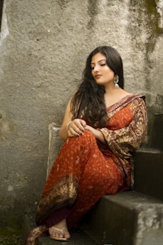 woman in orange and brown dress sitting on chair