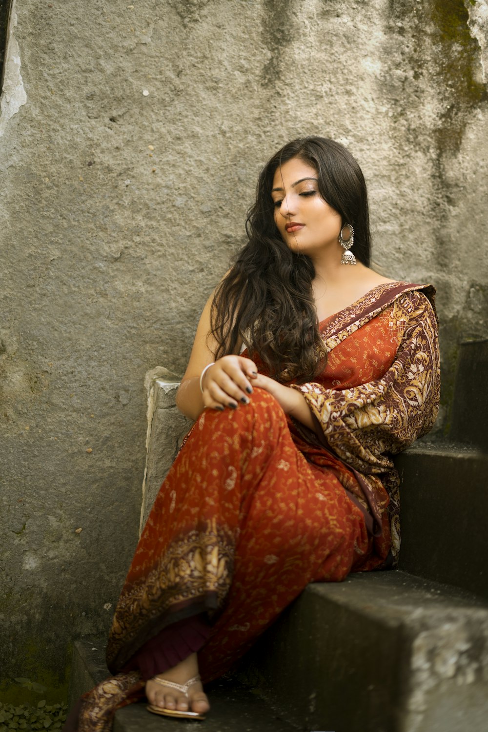 woman in orange and brown dress sitting on chair