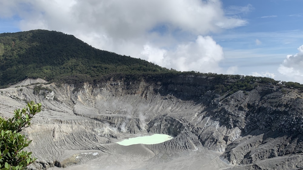 green and black mountain under white clouds and blue sky during daytime