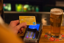 person holding yellow and blue card