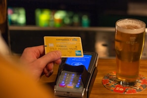 person holding yellow and blue card