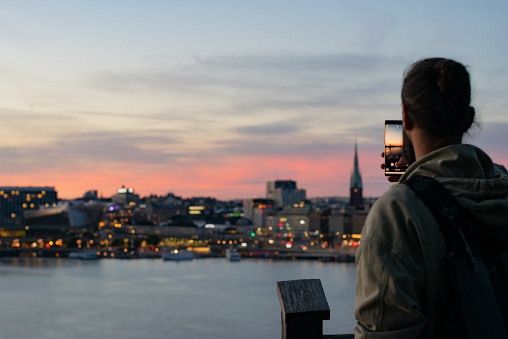 man in black jacket looking at city buildings during daytime