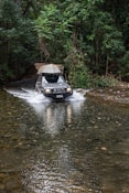 blue car on river during daytime