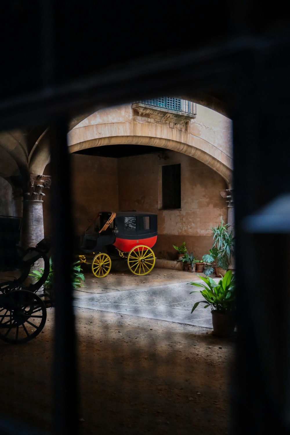 black and yellow motorcycle parked beside brown concrete building