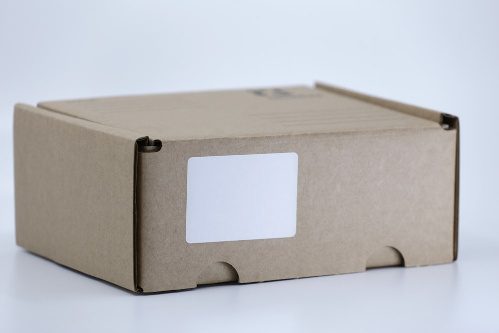 caja de cartón marrón sobre mesa blanca