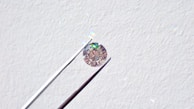 Close-up of a lab-grown diamond reflecting vibrant colors in natural light