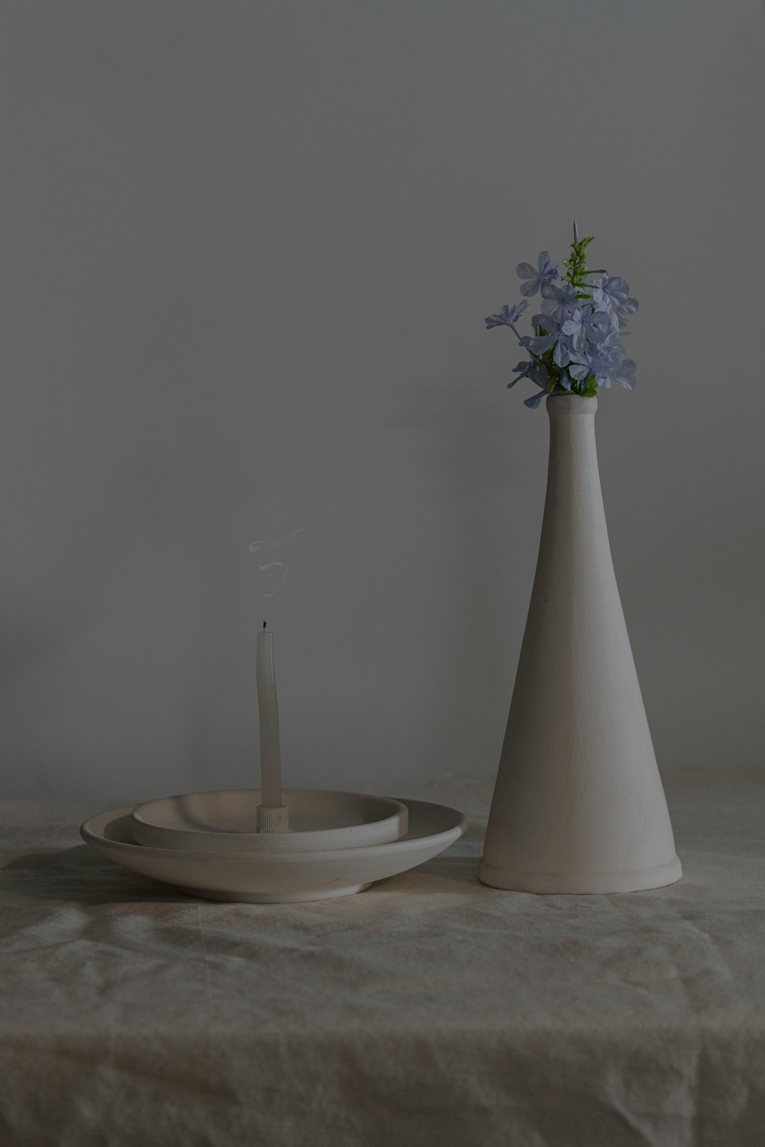 white ceramic vase with white flowers