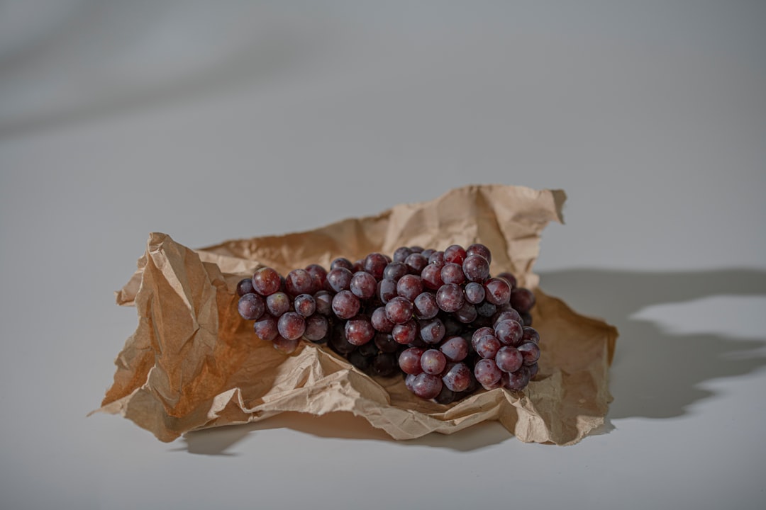 purple grapes on brown paper