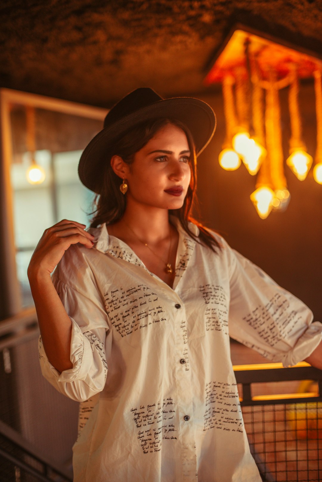 woman in white button up shirt wearing brown cowboy hat