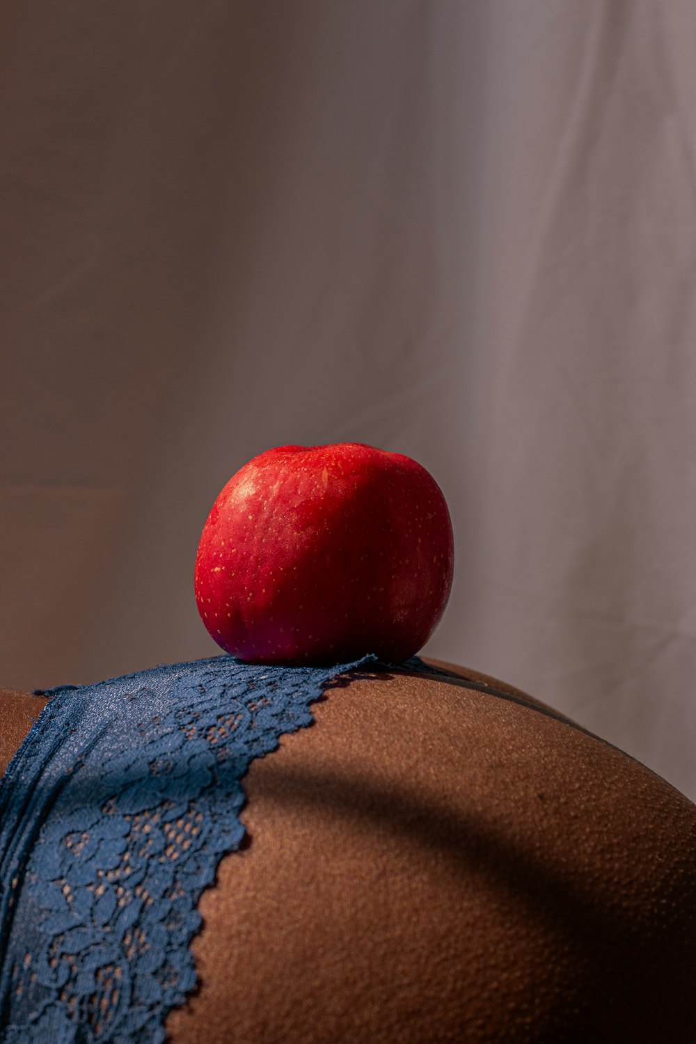 red apple on blue and white floral textile