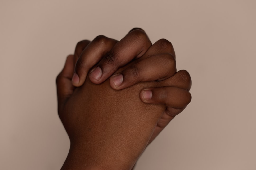 persons right hand on white surface