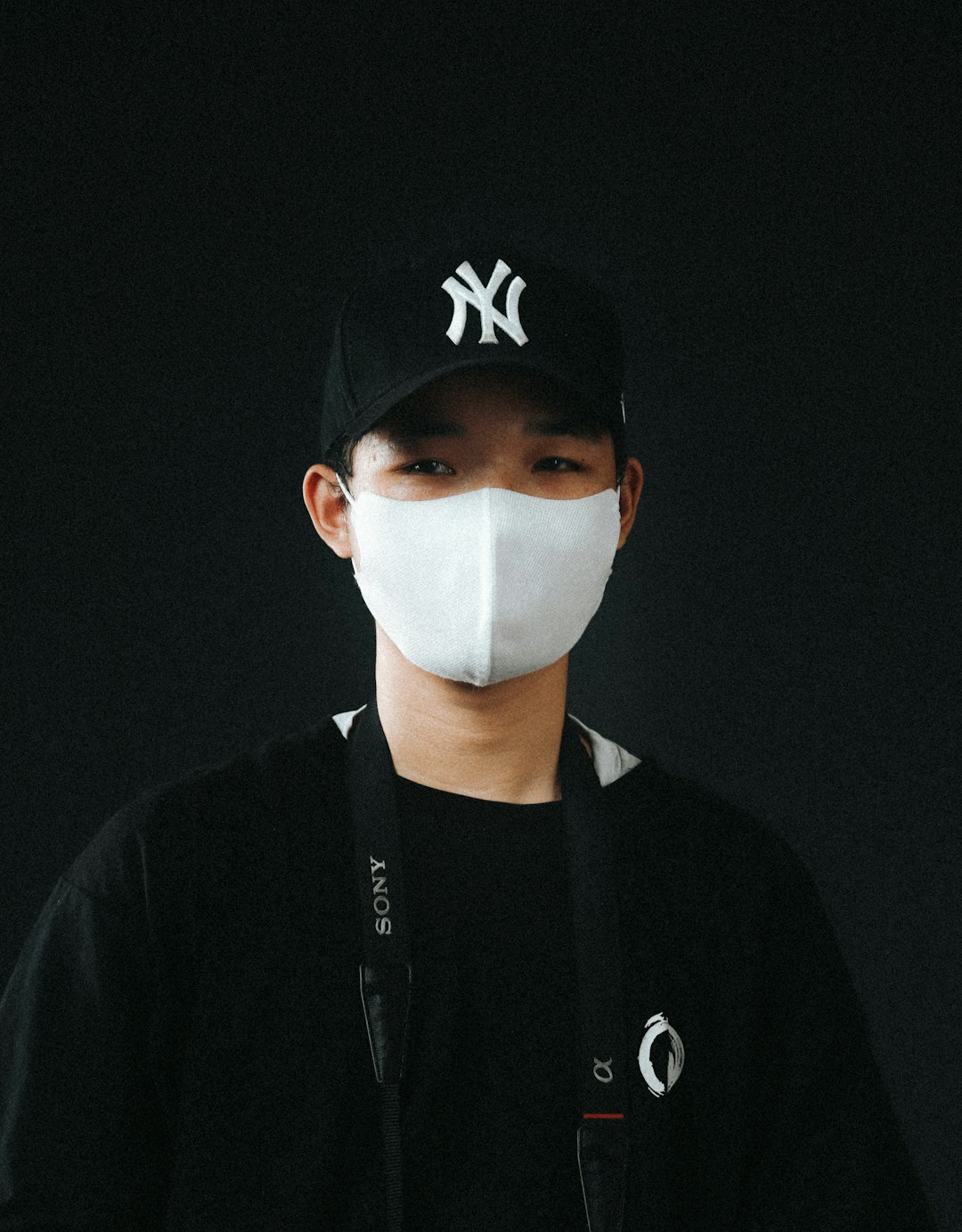 man in black and white nike crew neck shirt wearing white face mask