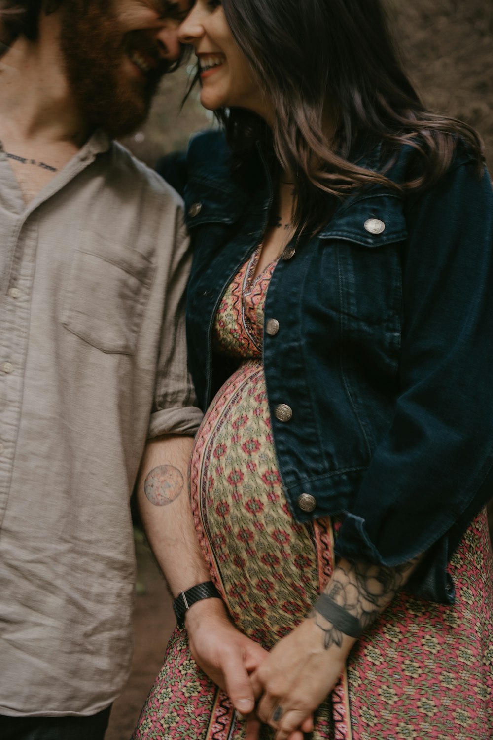 woman in blue denim jacket standing beside woman in gray shirt