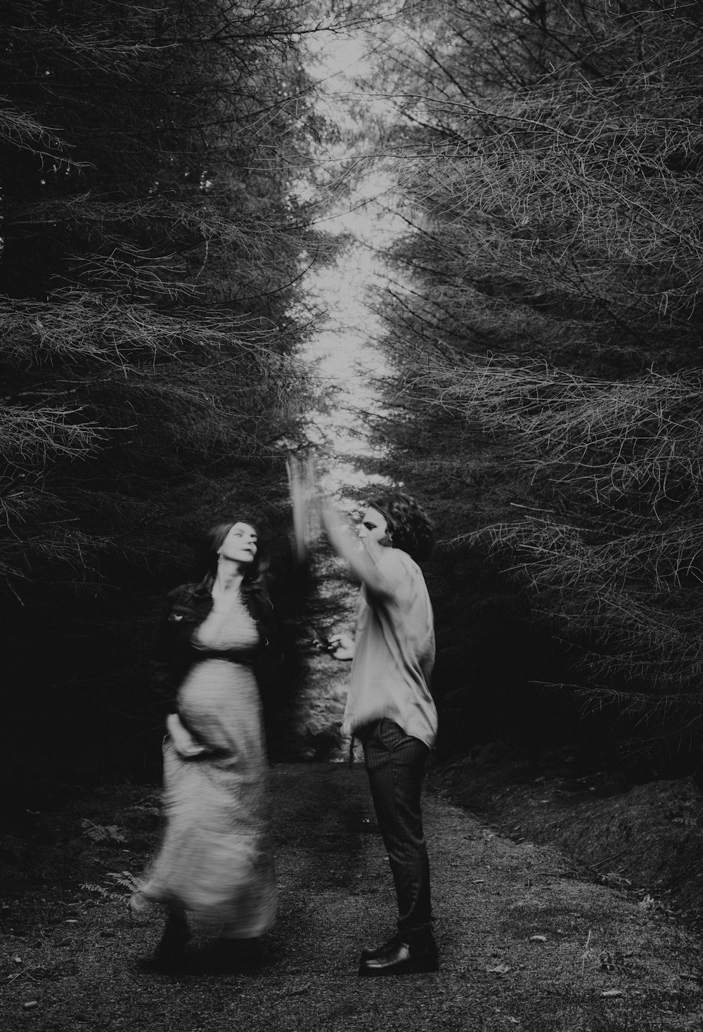 grayscale photo of man and woman holding hands