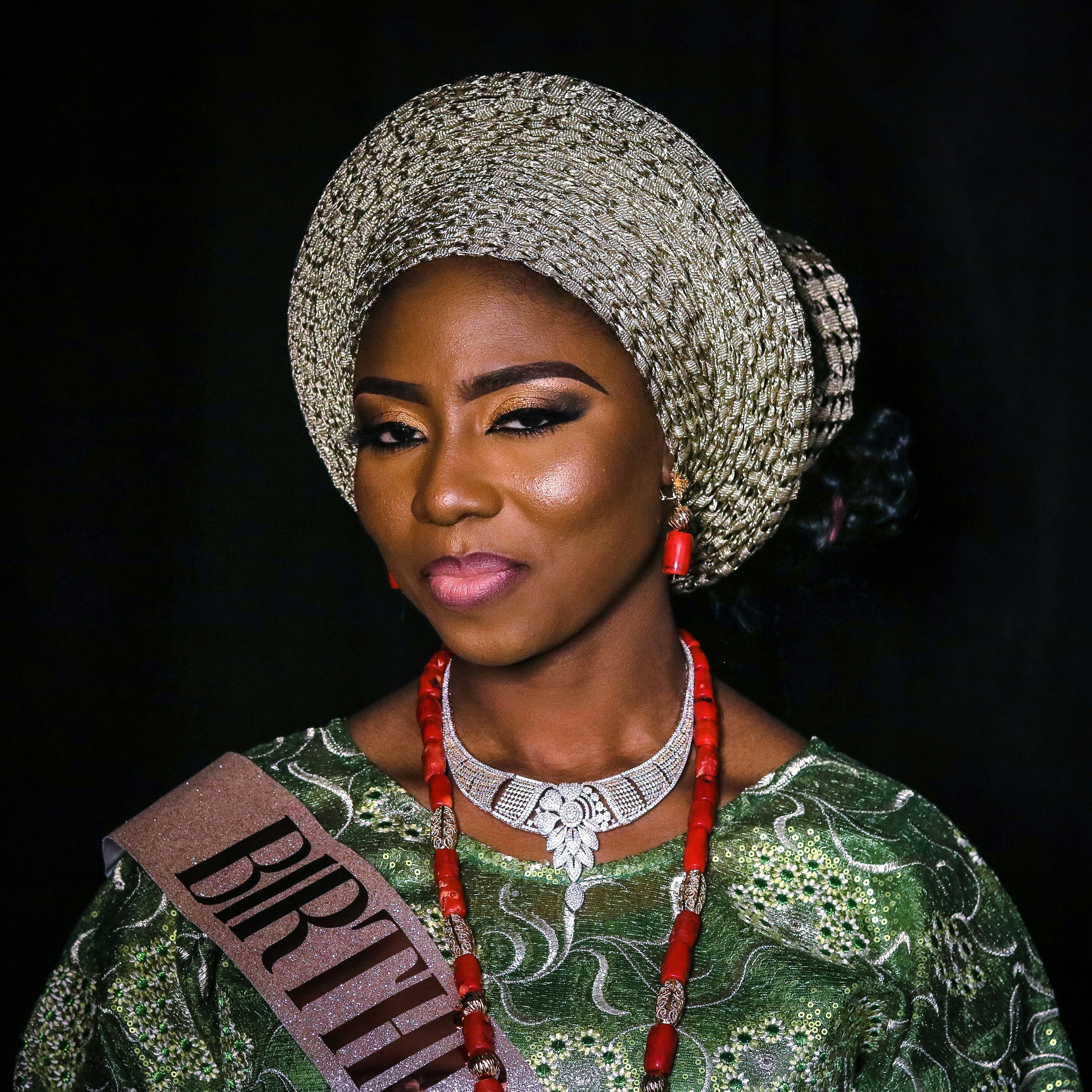 woman in green and white floral shirt wearing gray and black hat