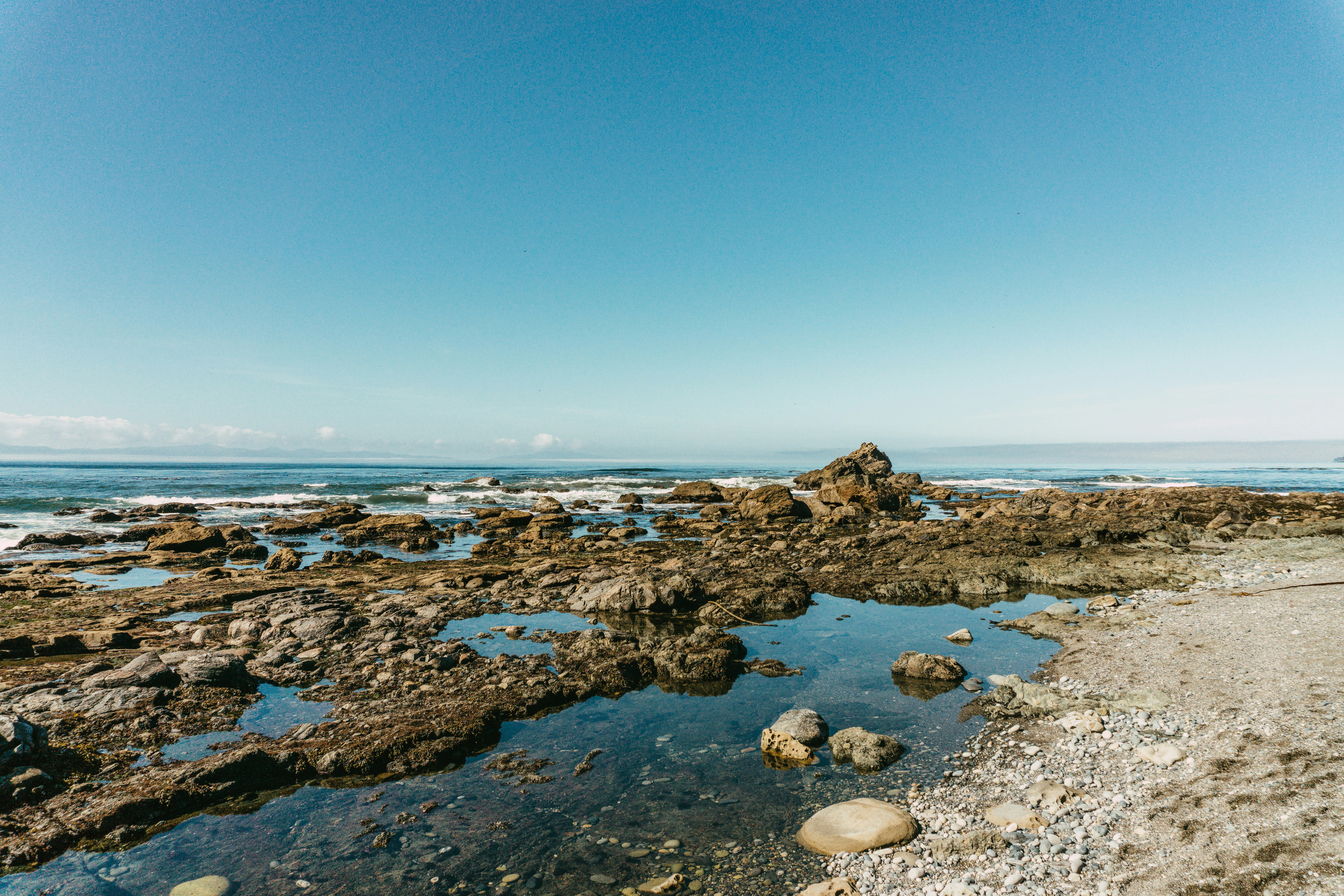 brown rocks on seashore during daytime