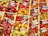 A vibrant assortment of various pepper varieties displayed in wooden crates. Each type of pepper is labeled with a card indicating its name and origin. The peppers range in color from bright red and yellow to orange and green, showcasing a diverse selection of shapes and sizes.