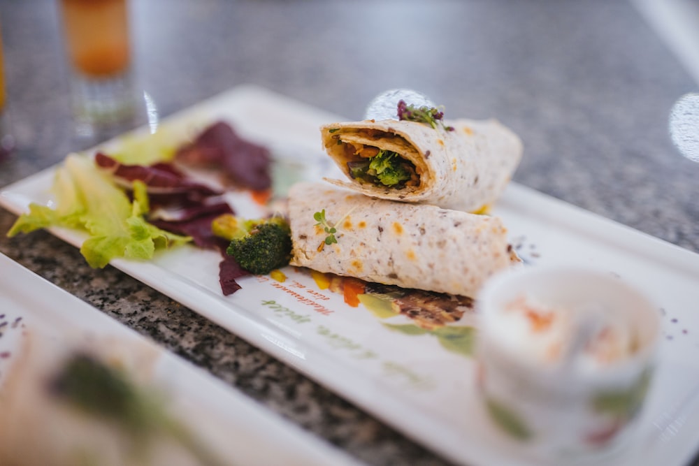 white ceramic plate with green vegetable and meat dish