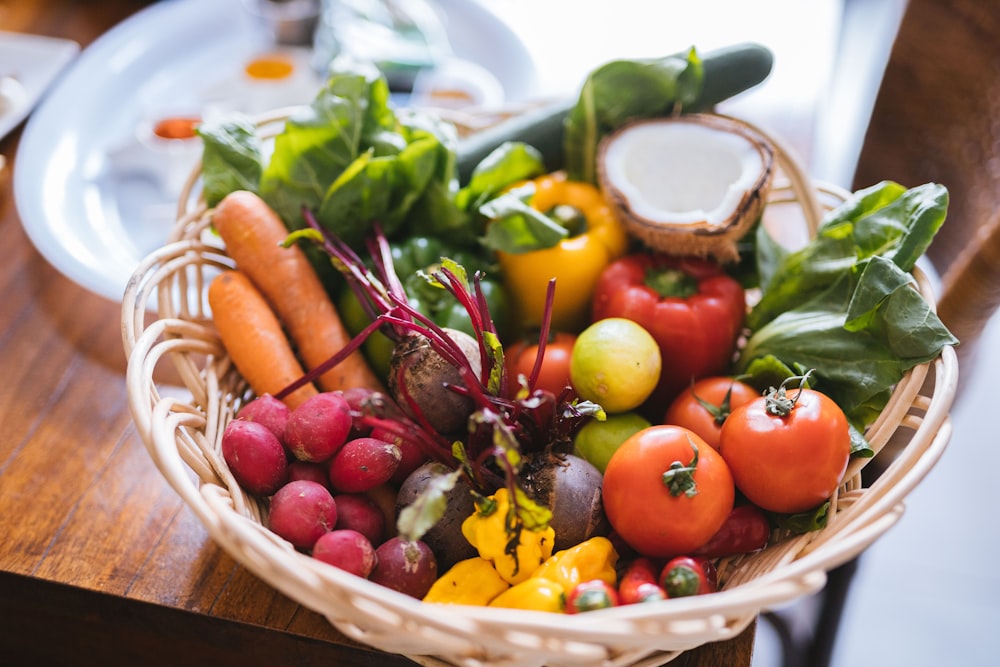 red and yellow tomatoes in brown woven basket